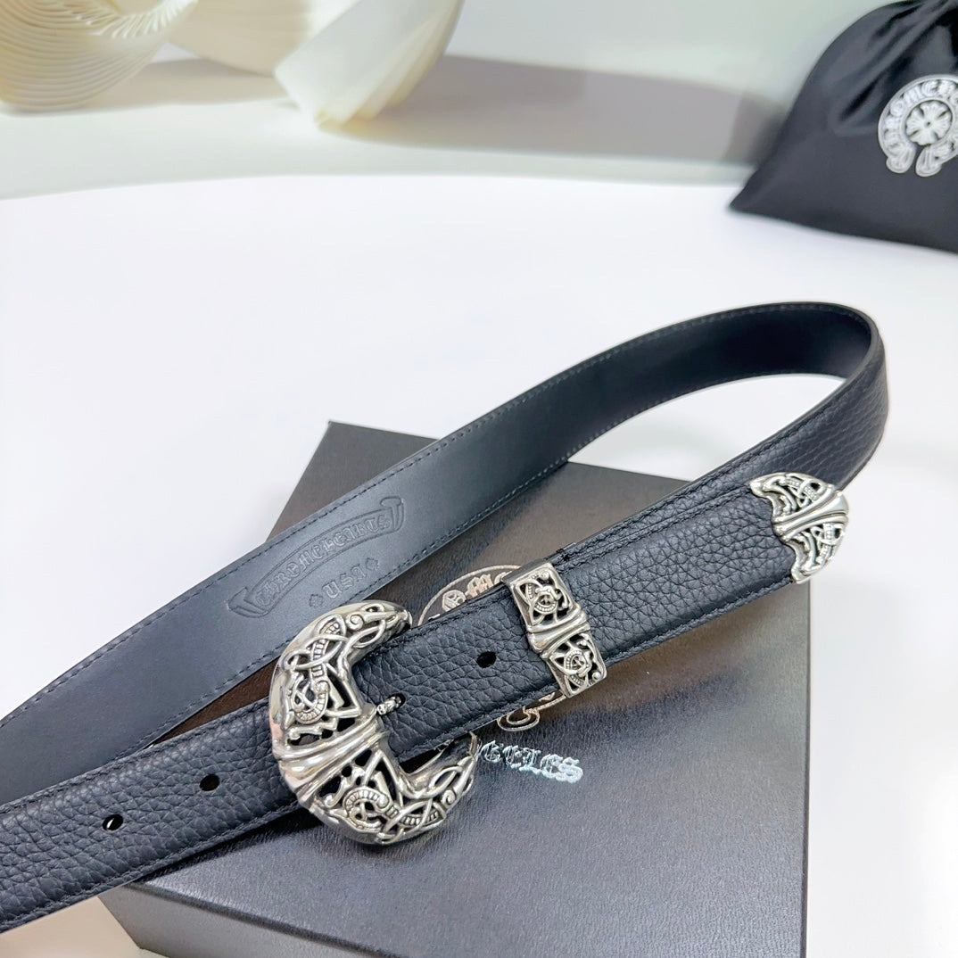 Dark leather belt with ornate silver buckle and keeper, close-up on the strap