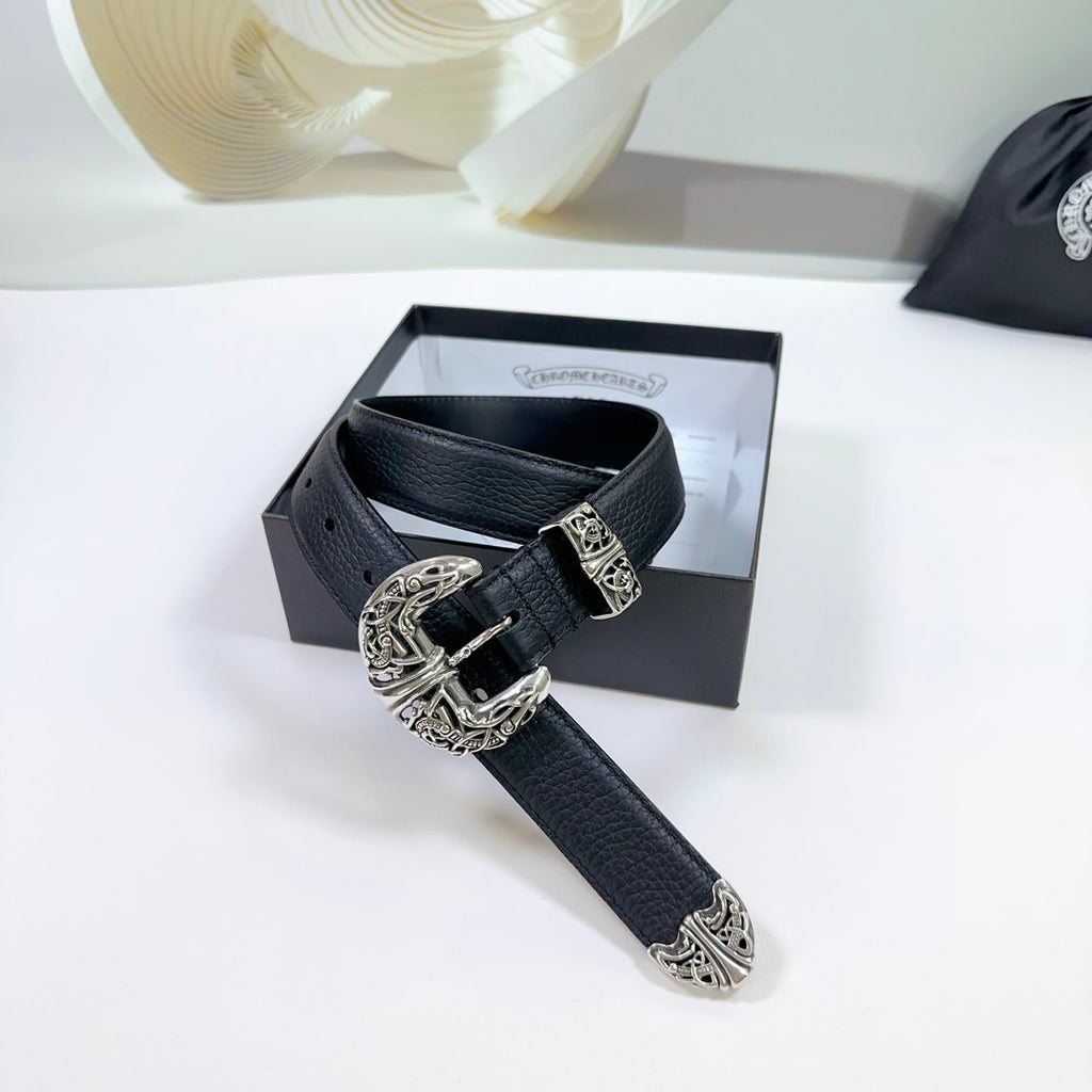 Dark leather belt with ornate silver buckle and decorative plate, on a gift box