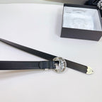 Black leather belt with large circular silver buckle and adjustable strap holes