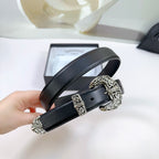 Black leather belt held up, ornate silver buckle with engraved details