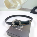 Black leather belt with ornate silver buckle and etched side plates