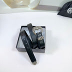 Black leather belt with ornate silver buckle and stitched holes, side view