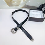 Black leather belt with decorative silver buckle, flat top view
