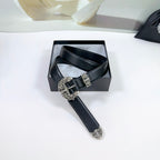 Black leather belt with decorative silver buckle and stitched holes, top view