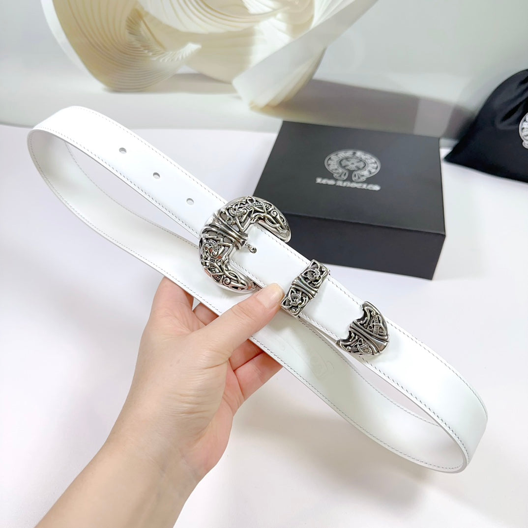 White leather belt close-up with silver buckle hardware and stitched strap edge