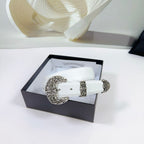 White leather belt with ornate silver buckle displayed in an open gift box