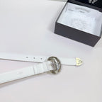 White leather belt end with round ornate silver buckle and hanging size tag