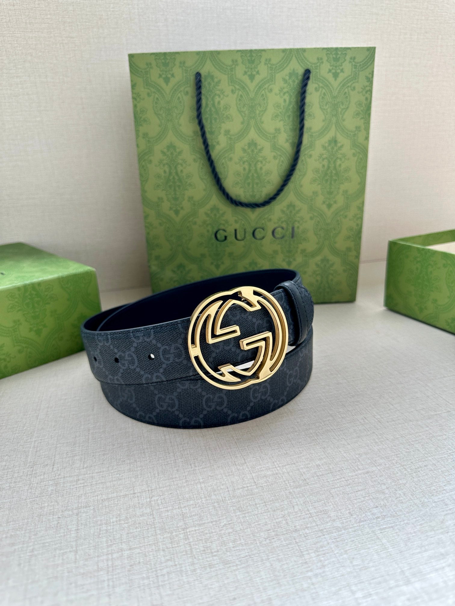 Gucci belt with dark blue patterned strap and gold-toned double-G buckle