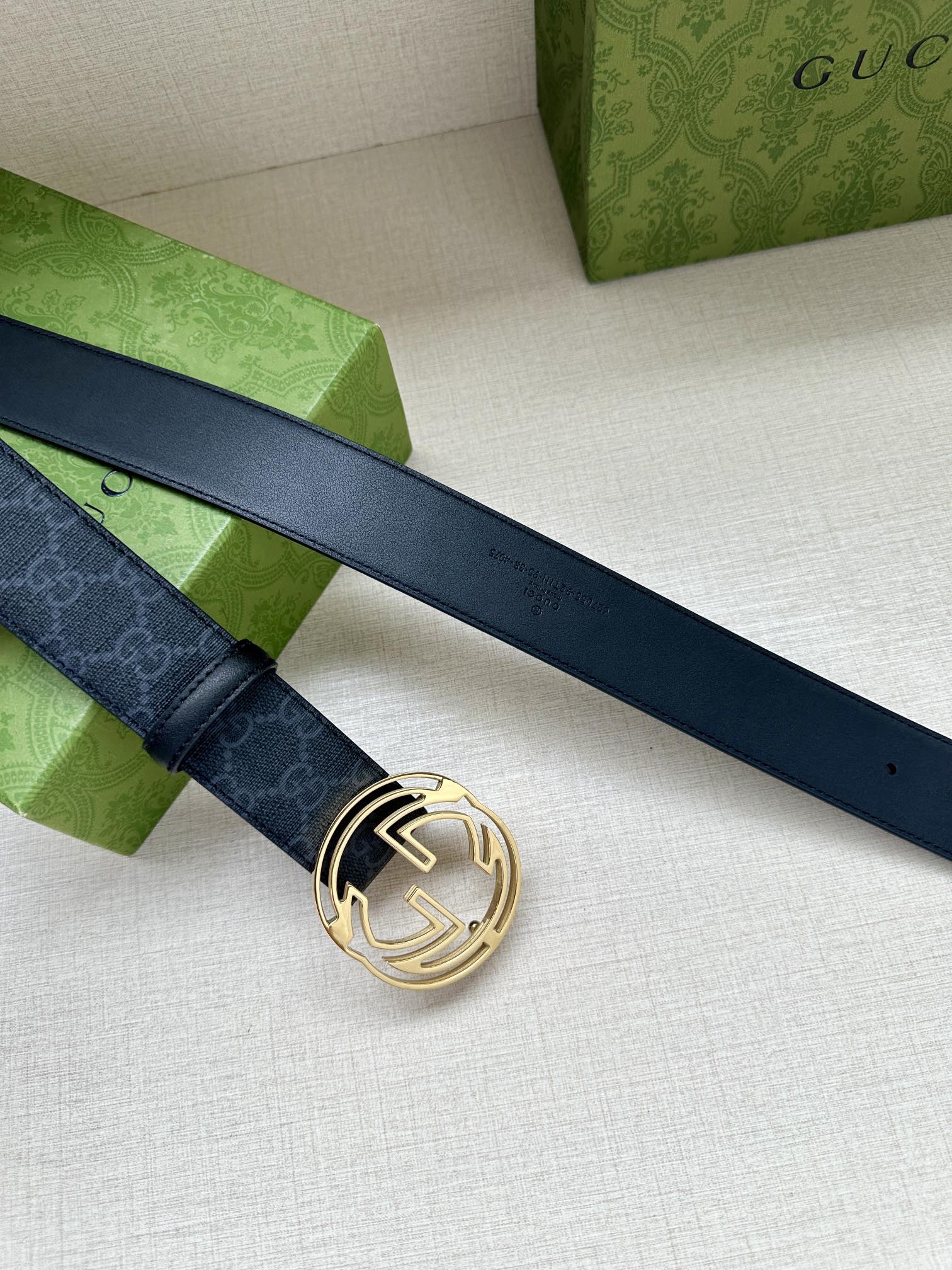 Gucci belt with dark blue patterned strap and gold-toned double-G buckle
