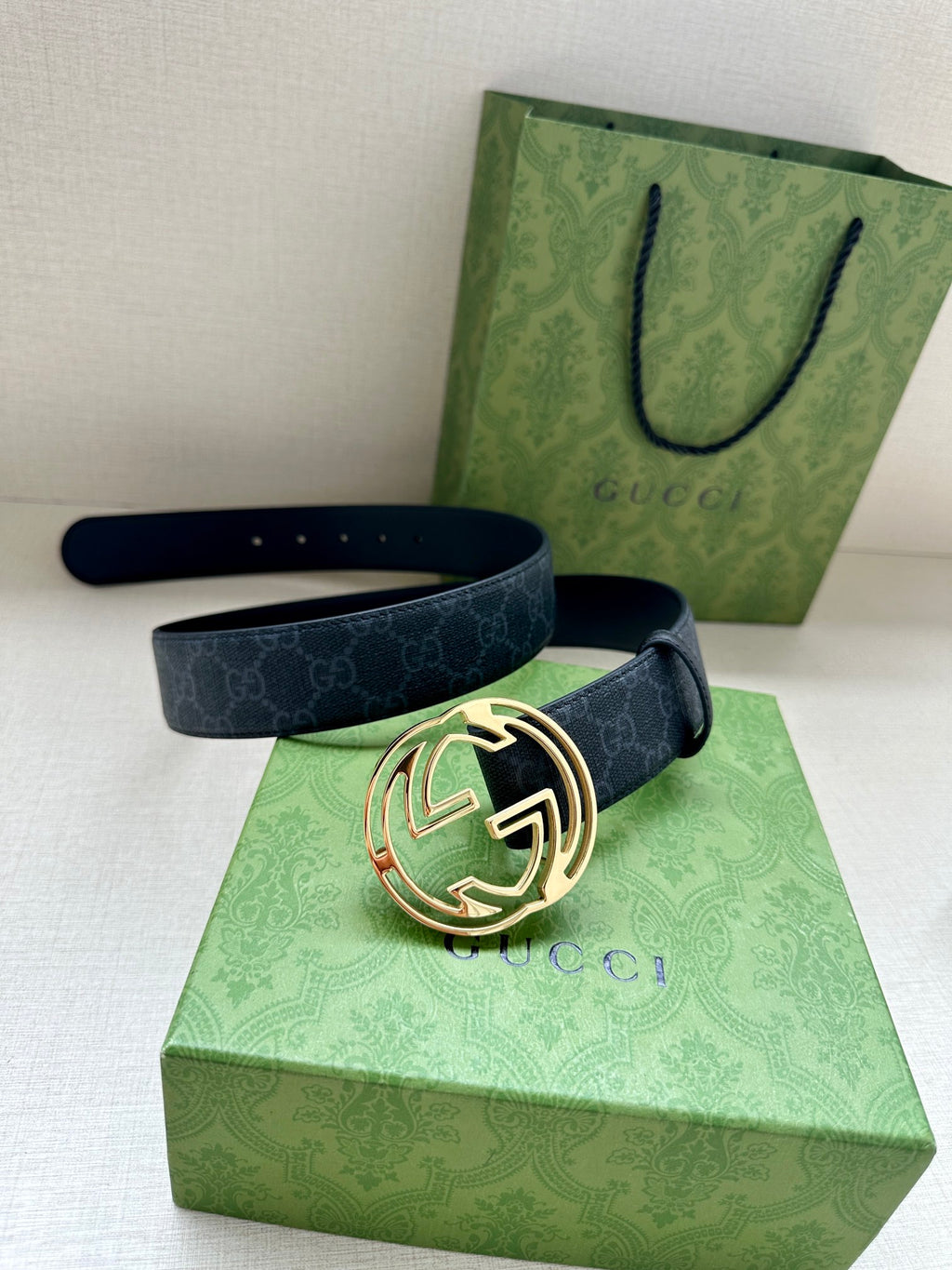 Gucci belt with dark blue strap and gold-toned double-G buckle