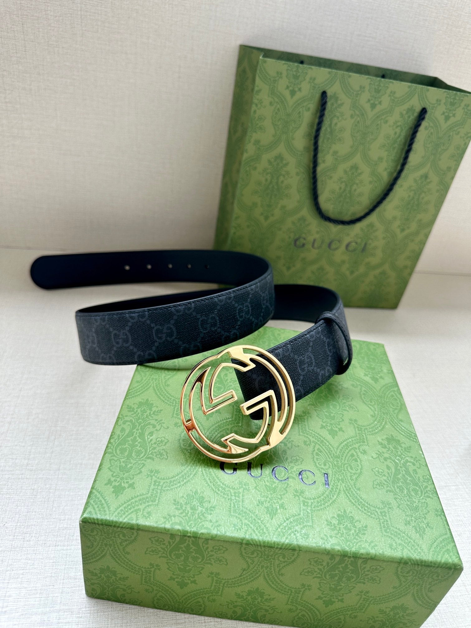 Gucci belt with dark blue strap and gold-toned double-G buckle