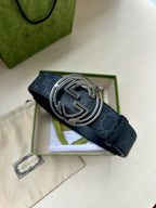 Gucci belt close-up: dark blue patterned strap with silver double-G buckle