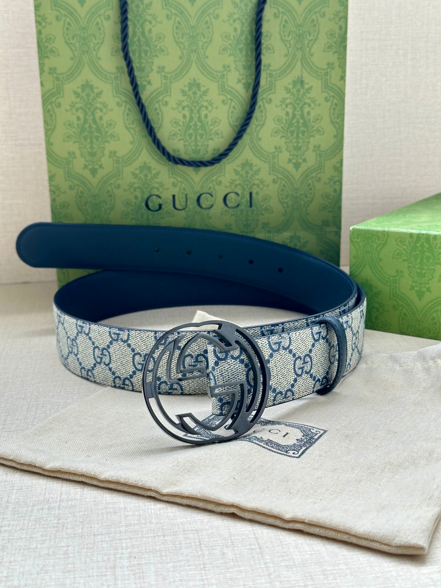 Gucci belt with blue GG patterned strap and dark blue leather, silver interlocking G buckle