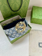 Gucci belt in open box with blue GG canvas strap and gold-tone interlocking G buckle