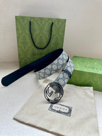 Gucci belt with blue GG canvas strap and silver interlocking G buckle on dark blue backing
