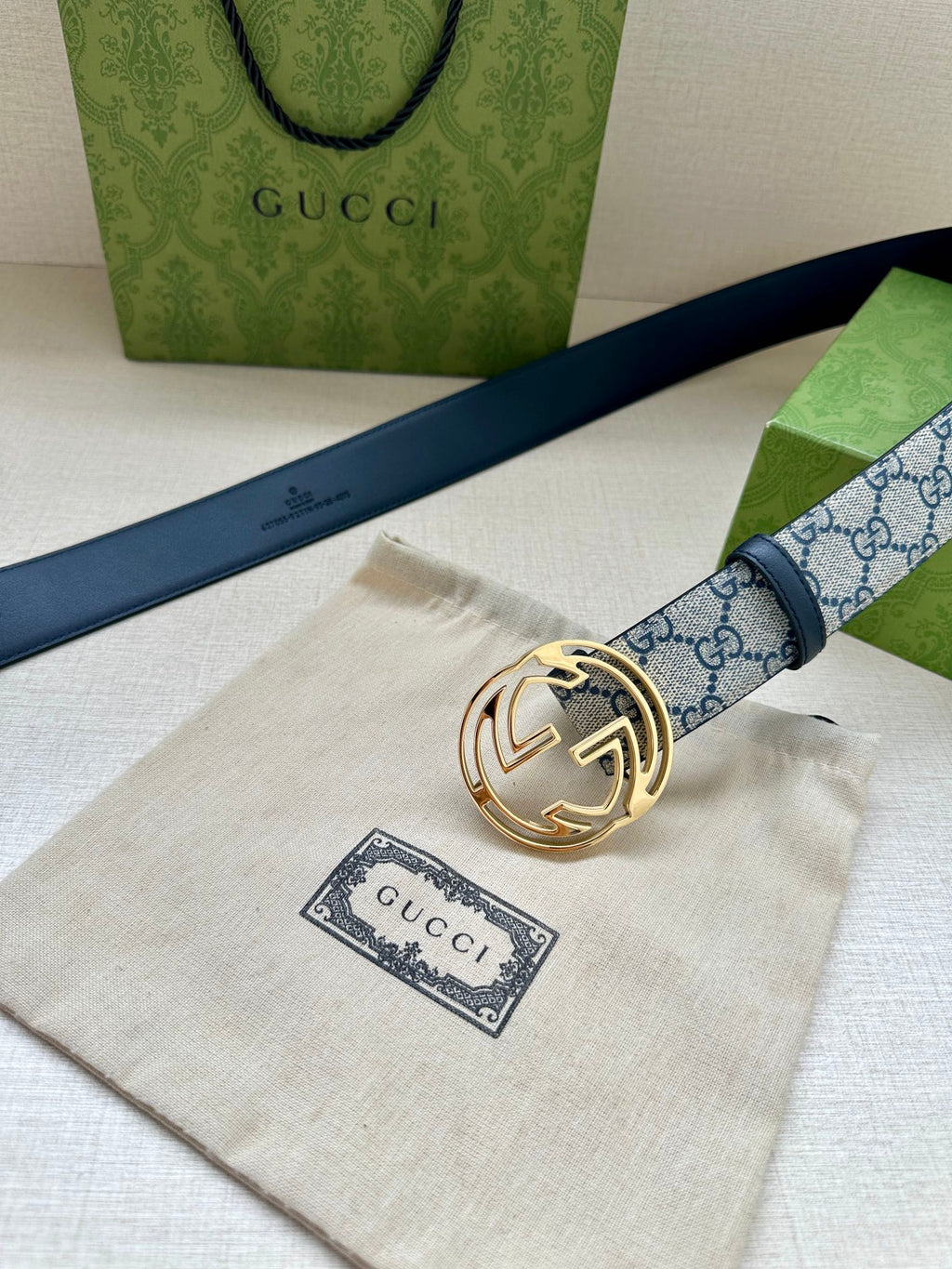 Gucci belt with blue GG canvas strap, gold-tone interlocking G buckle and dark blue leather