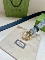 Gucci belt with blue GG canvas strap, gold-tone interlocking G buckle and dark blue leather