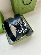 Gucci belt with dark blue strap and silver GG buckle, shown in presentation box.
