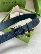Gucci belt with dark blue leather strap and silver double-G buckle, angled view.