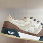 Fendi sneaker side view with cream leather, brown suede, dark blue band and sole
