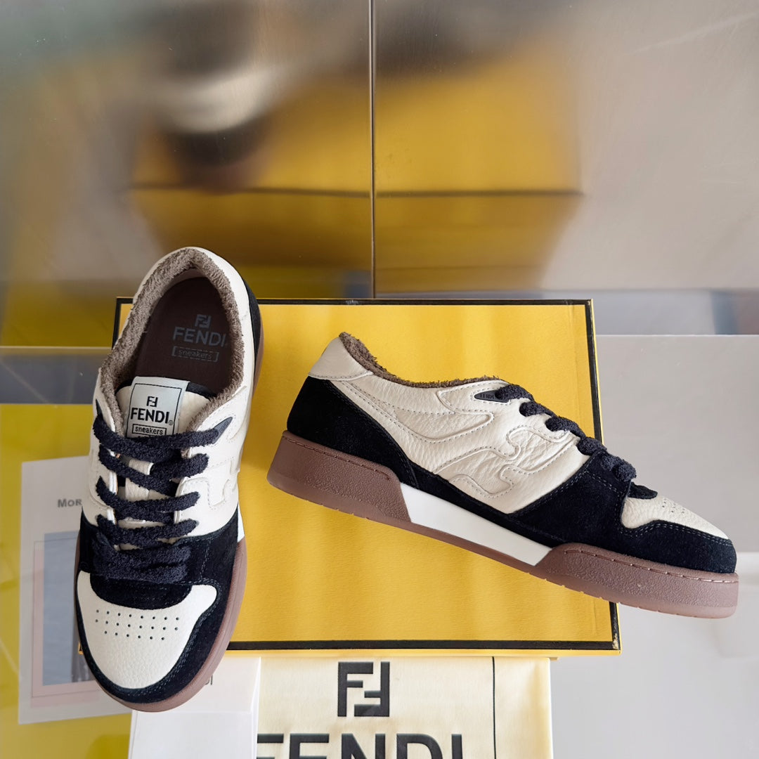 Low-top unisex sneaker with white upper, navy details, and a brown side panel