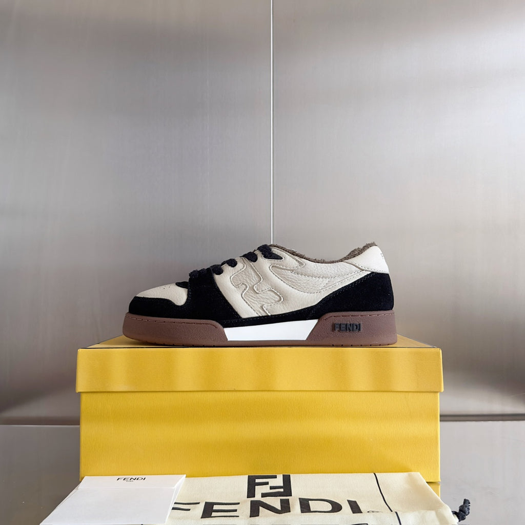 Low-top unisex sneaker on box, white upper with navy panels and brown sole