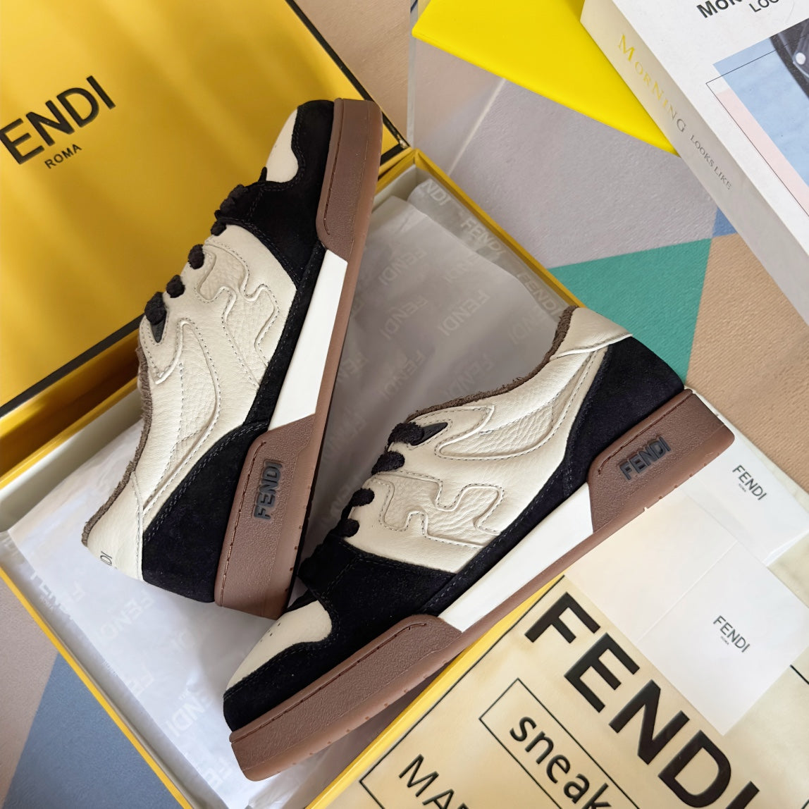 Low-top sneaker pair with cream and navy color-blocking and brown heel panel