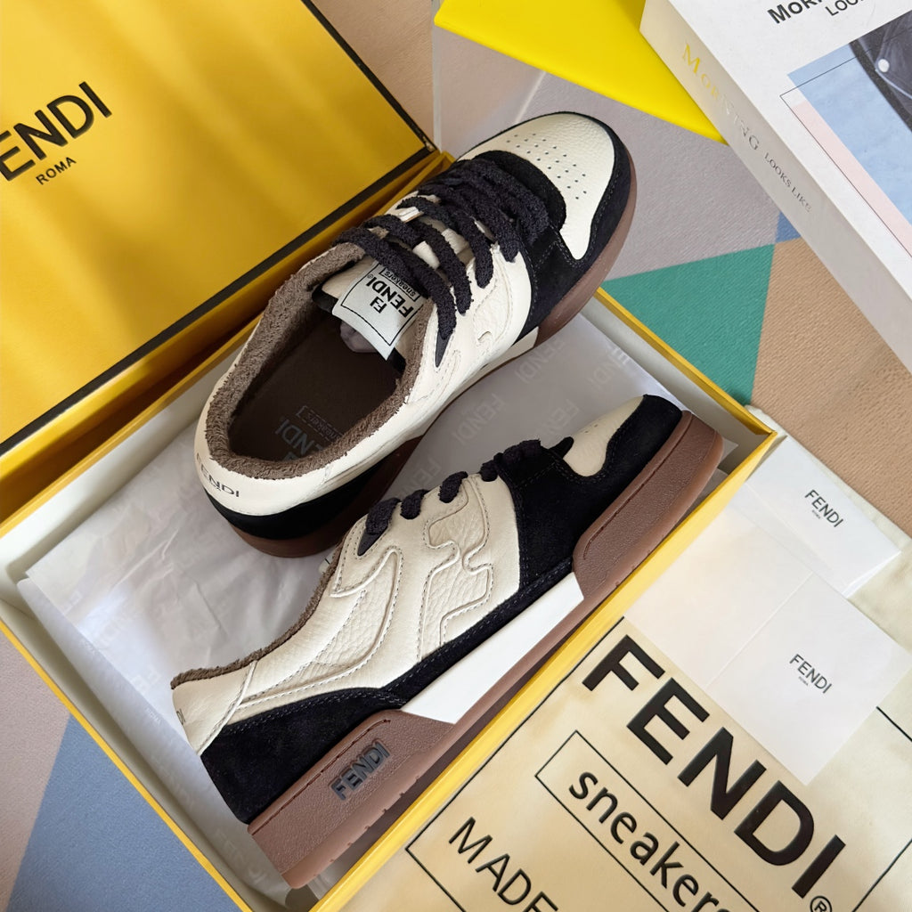 Low-top sneaker pair in white and navy with brown heel tab and lace-up front