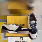 Low-top sneaker pair, white with navy accents and FENDI logo on the tongue
