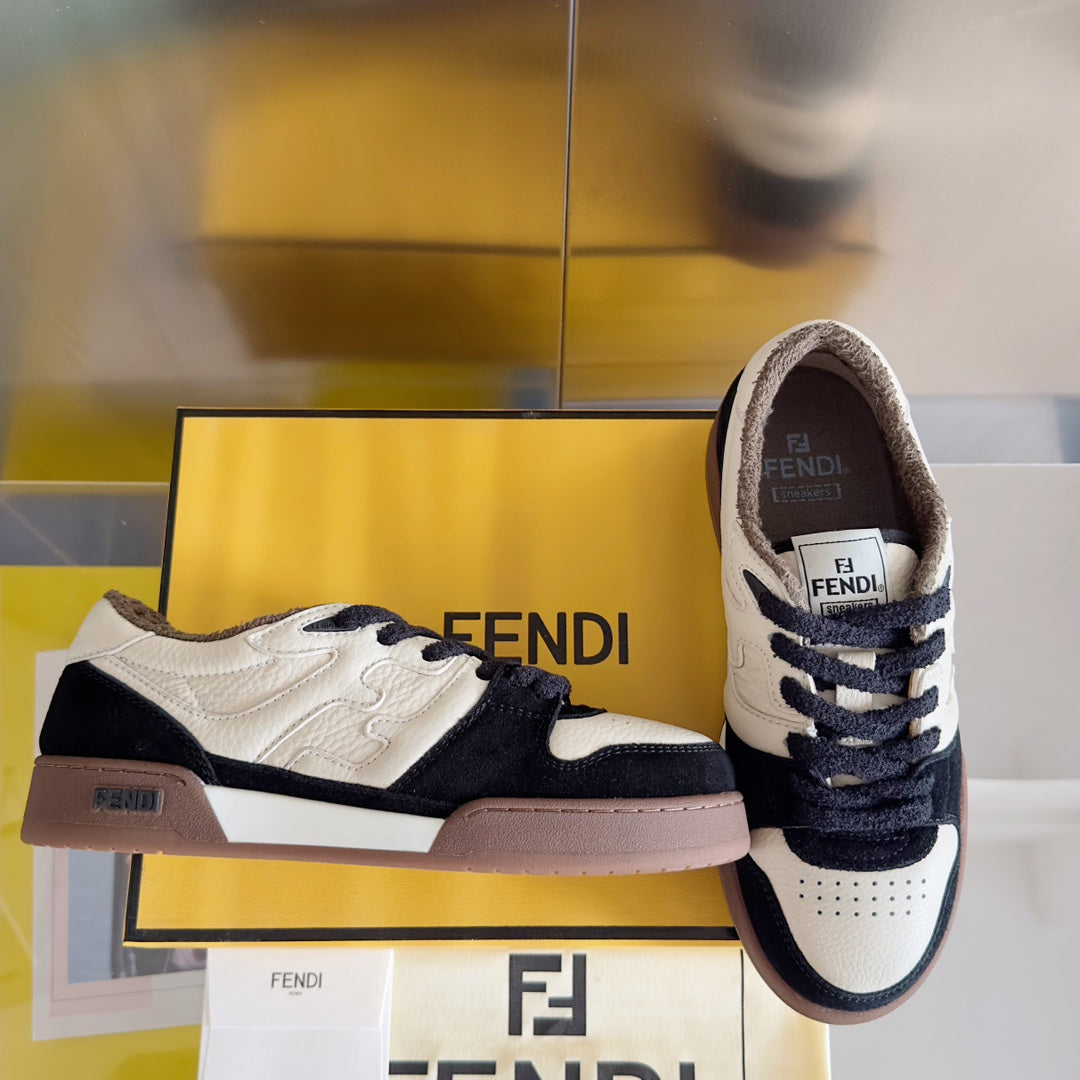 Low-top sneaker pair, white with navy accents and FENDI logo on the tongue