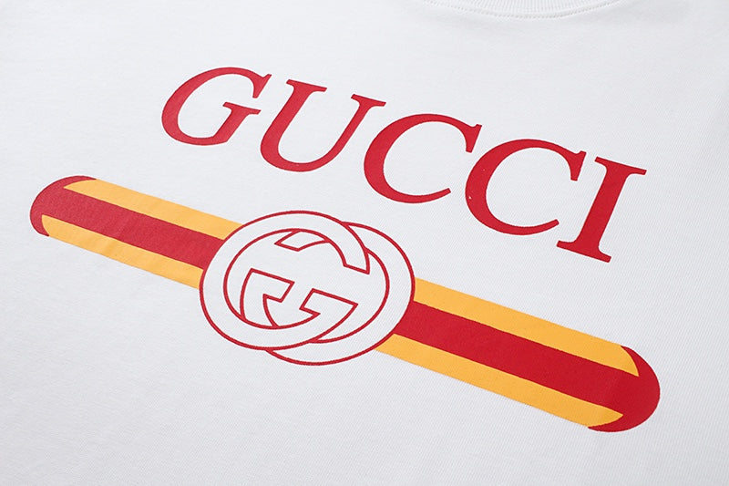 White Gucci T-shirt close-up of red “GUCCI” text and striped graphic