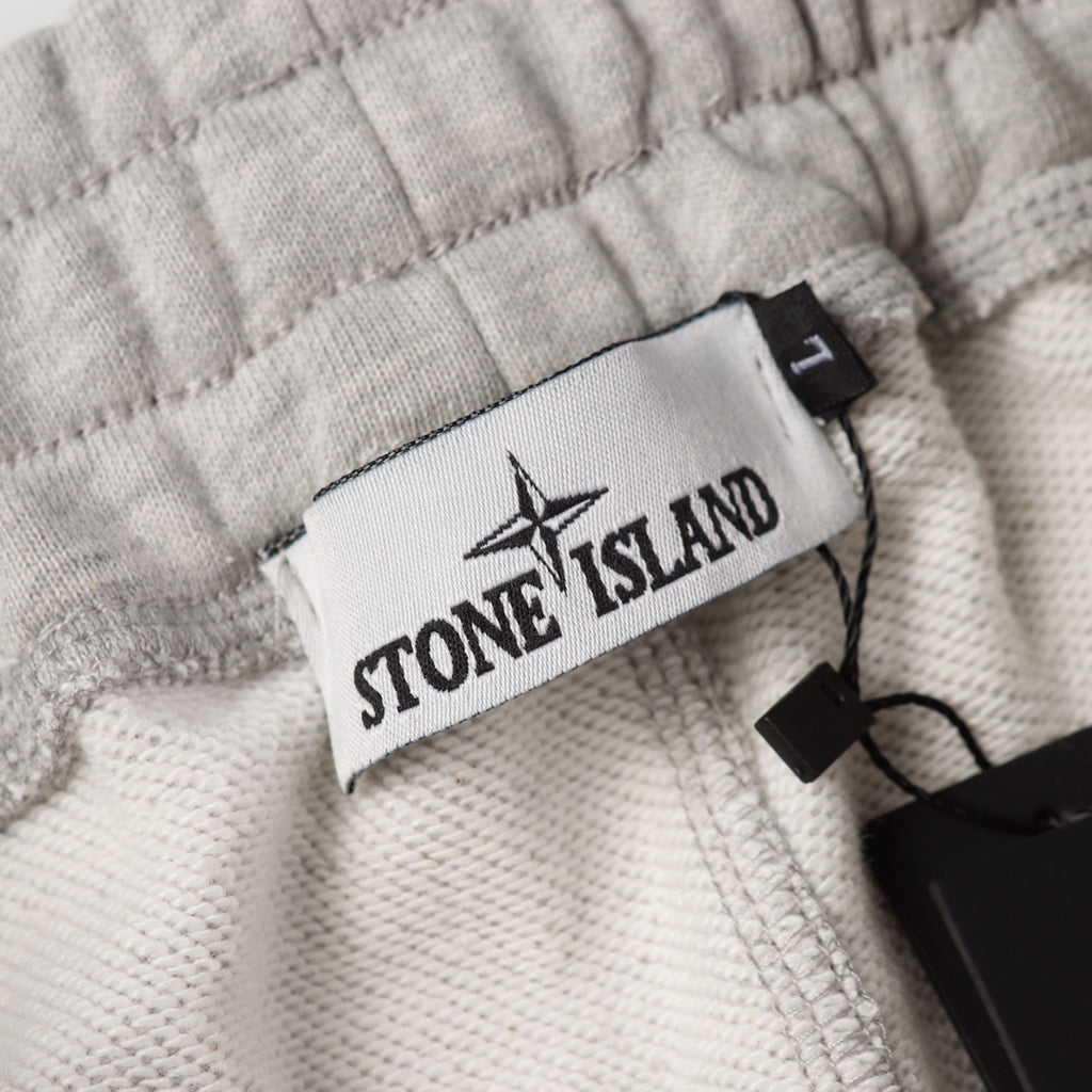 Stone Island logo patch label on light gray sweatpants waistband