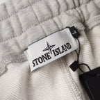 Stone Island logo patch label on light gray sweatpants waistband