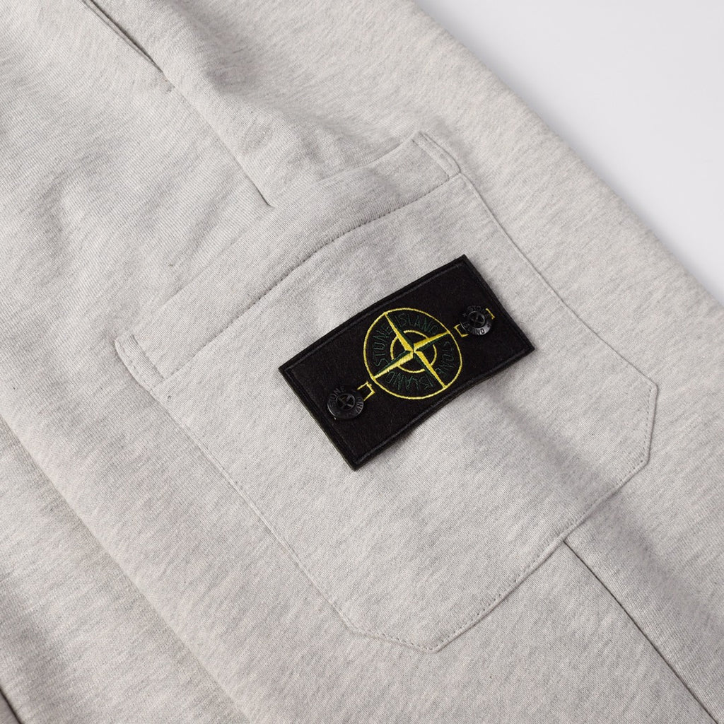 Light gray sweatpants with black patch logo on right front pocket