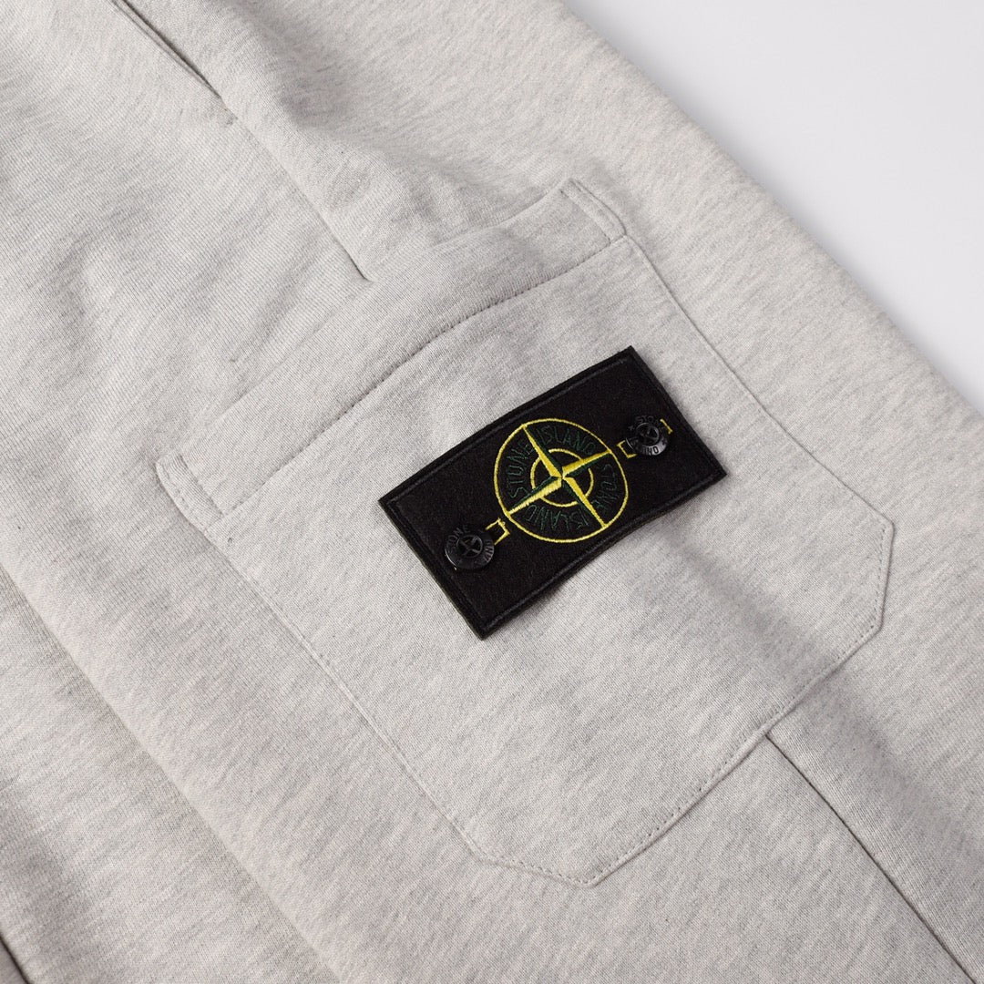 Light gray sweatpants with black patch logo on right front pocket