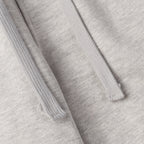Light gray sweatpants fabric with stitched seams and drawstring channel