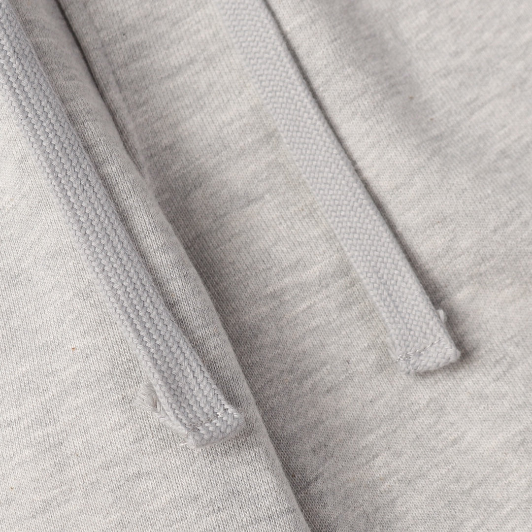 Light gray sweatpants fabric with stitched seams and drawstring channel