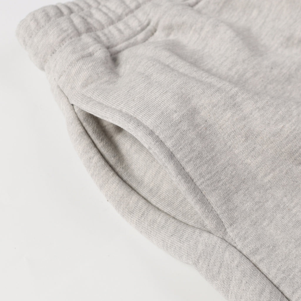 Light gray sweatpants pocket and folded fabric near the waistband