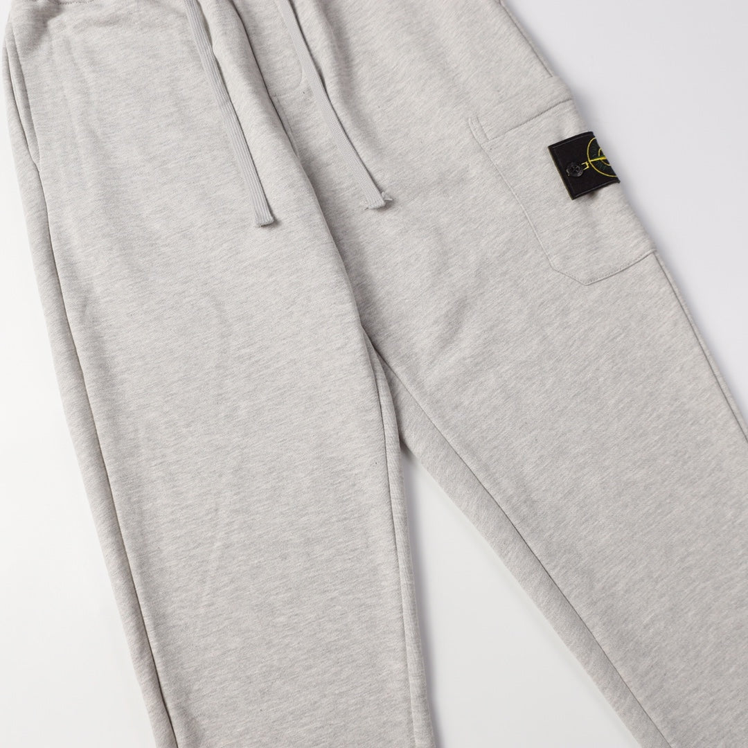 Light gray sweatpants front with drawstring and relaxed tapered legs
