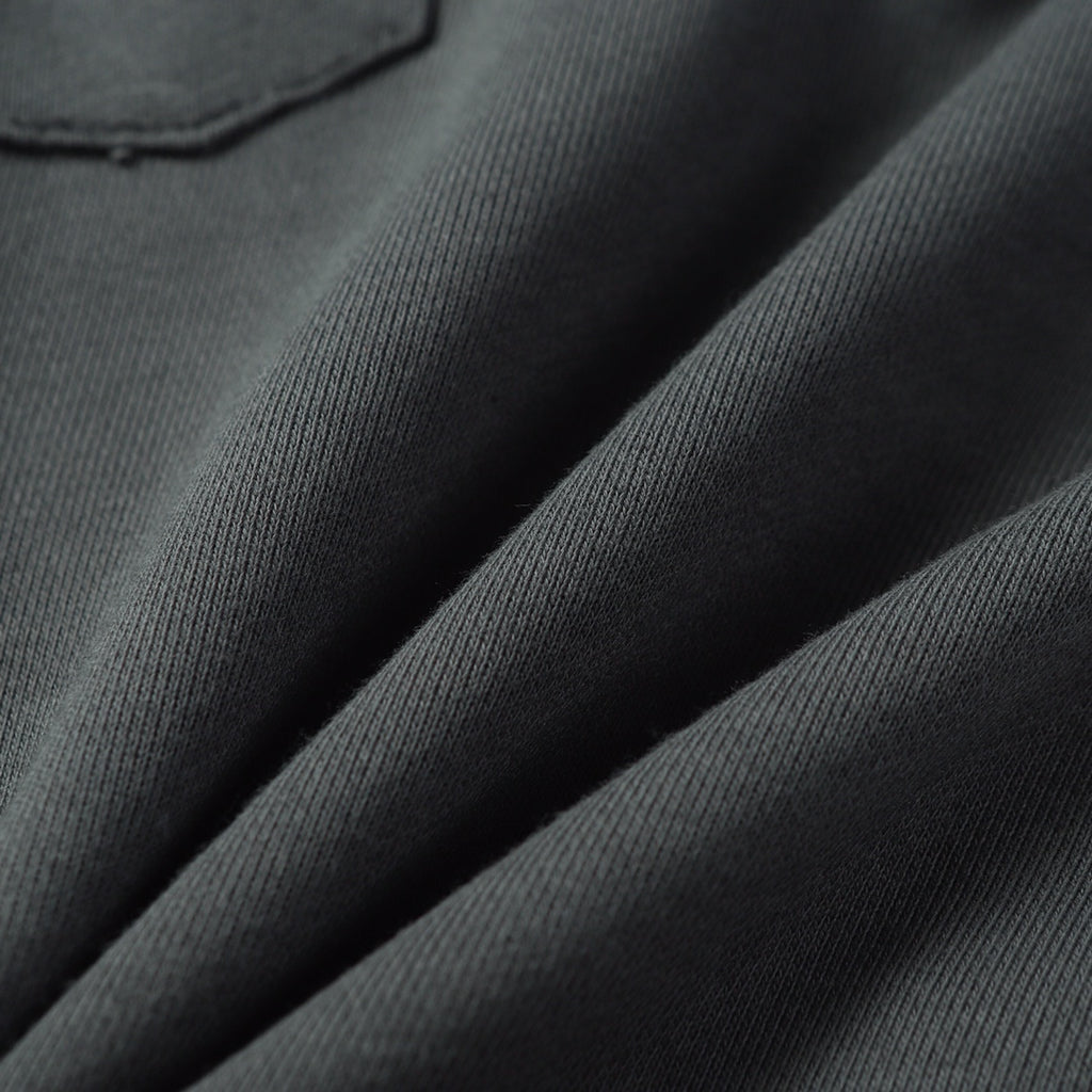 Charcoal gray knit fabric texture on sweatpants legs
