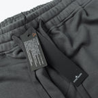 Charcoal gray sweatpants with inner tags and Stone Island brand label