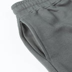 Charcoal gray tapered pant leg with cuffed hem and side seam