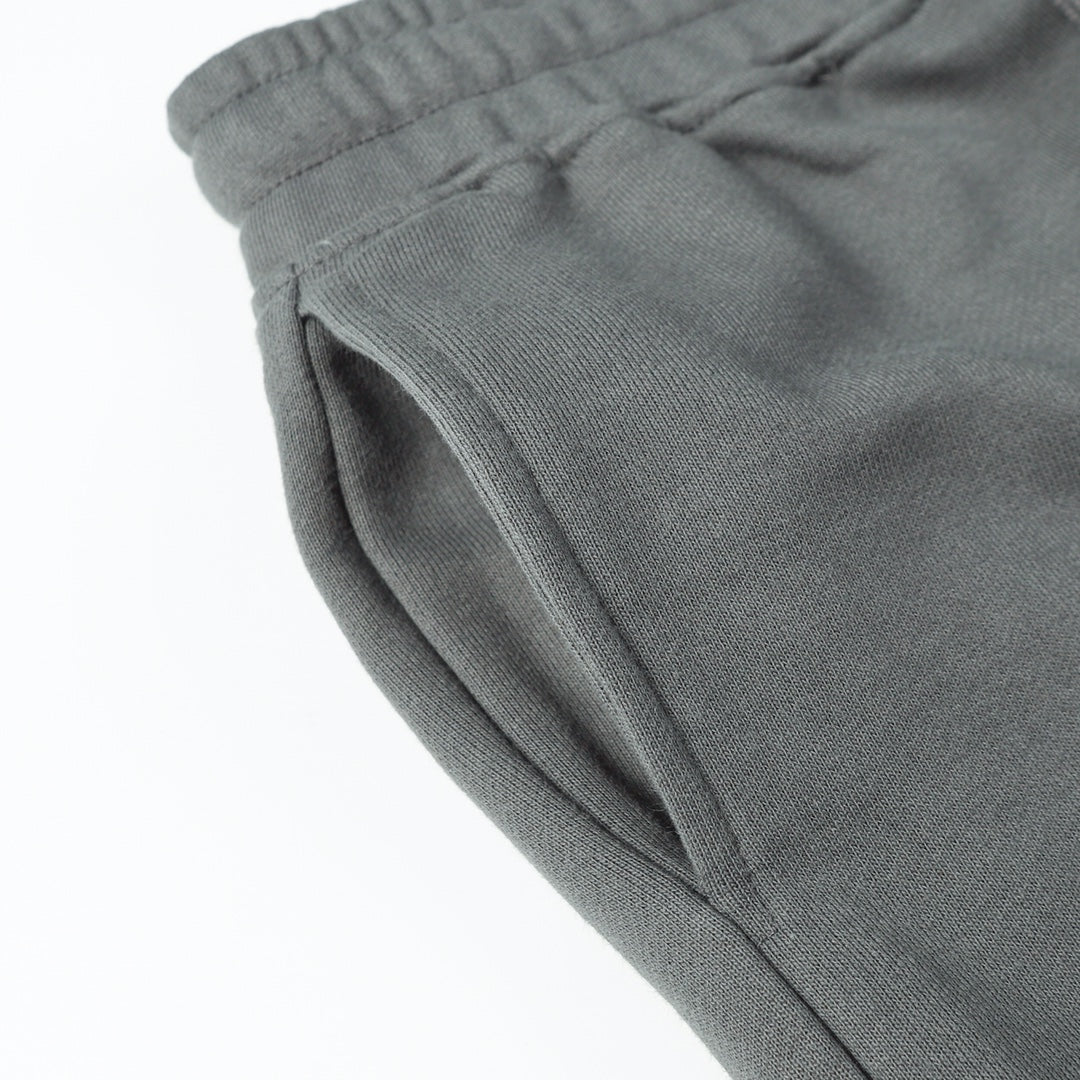 Charcoal gray tapered pant leg with cuffed hem and side seam