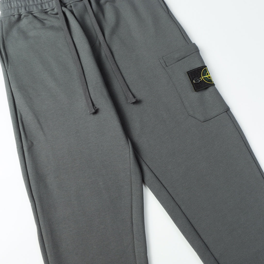 Charcoal gray drawstring pants with side cargo pocket and Stone Island patch