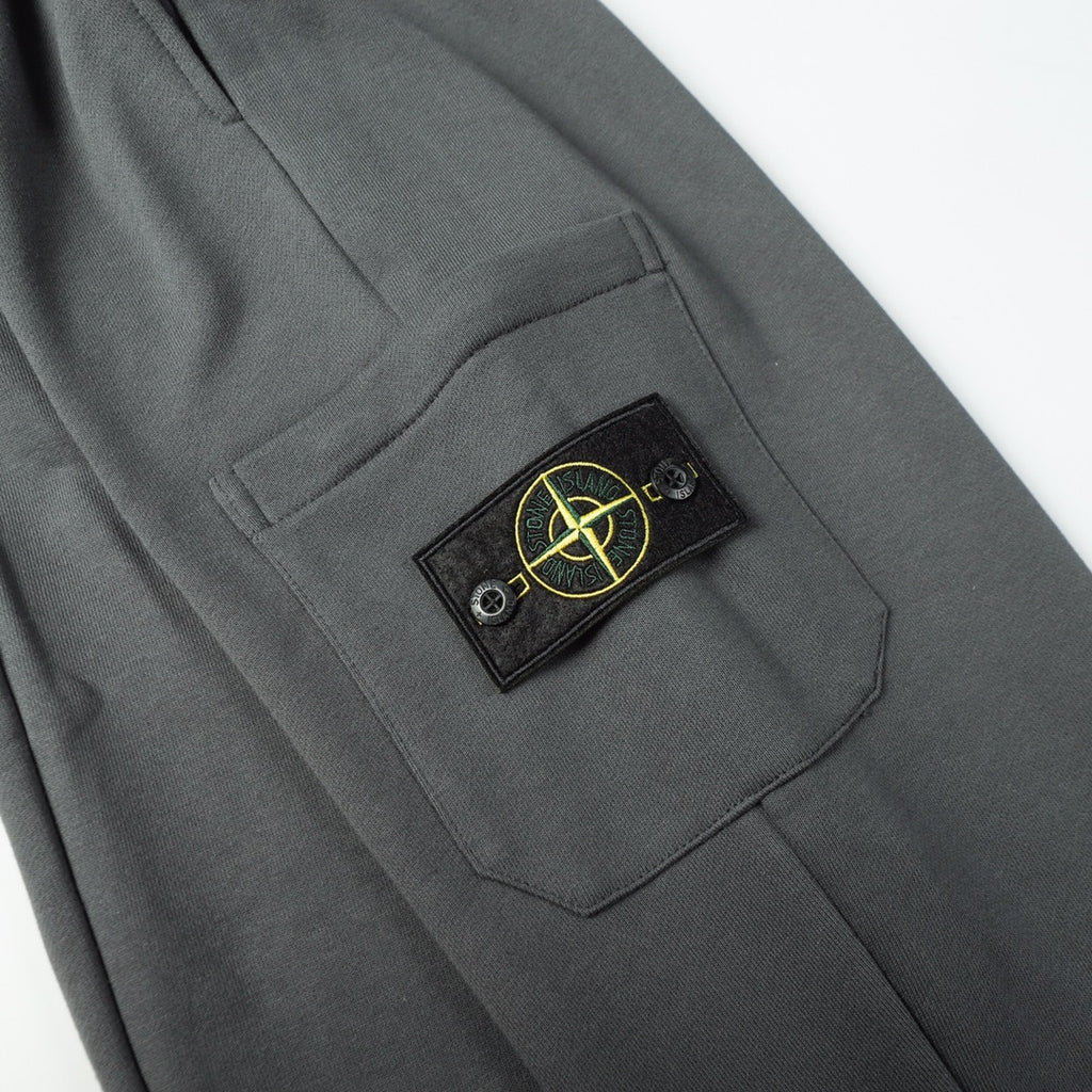 Charcoal gray cargo pocket with Stone Island patch and stitched pocket edge