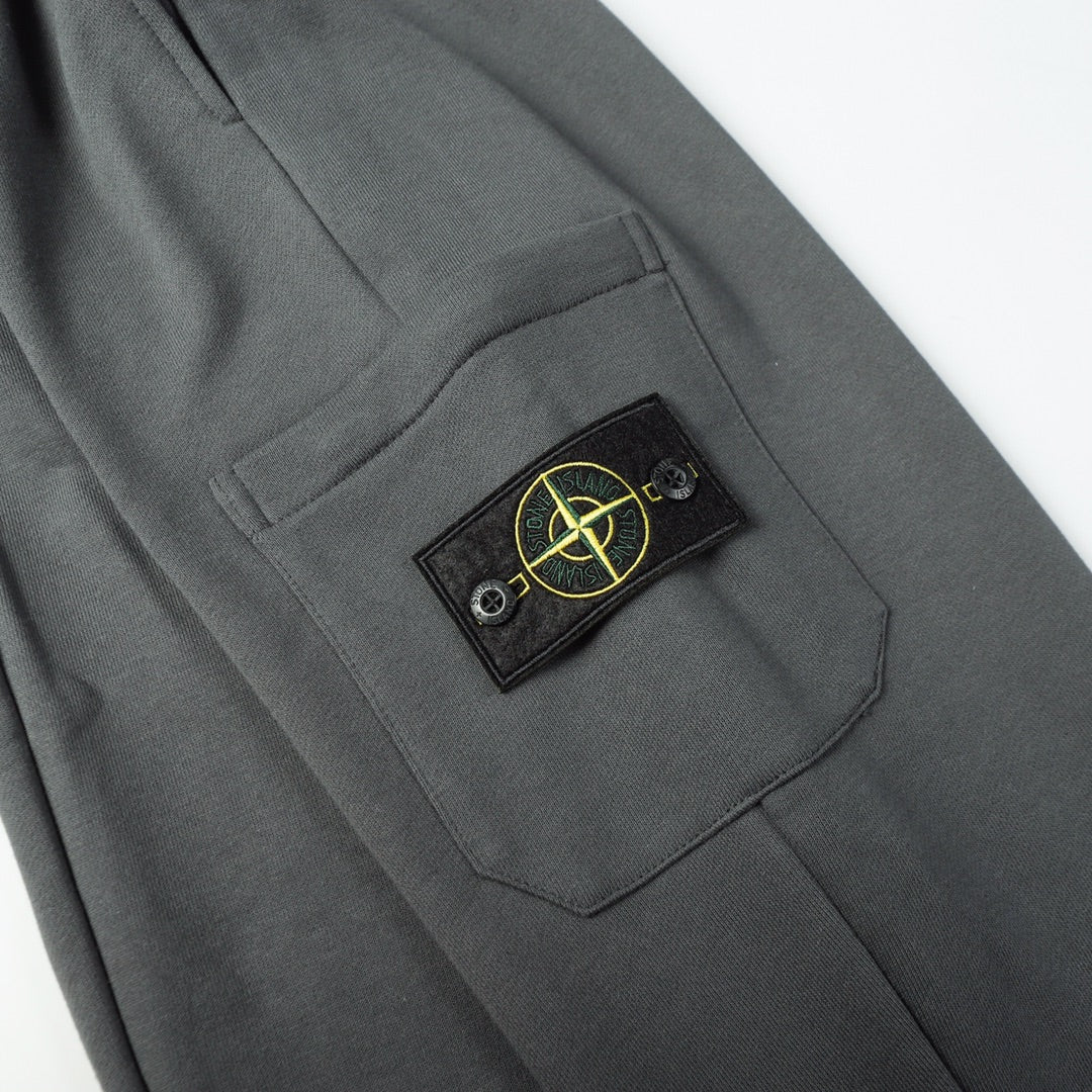 Charcoal gray cargo pocket with Stone Island patch and stitched pocket edge