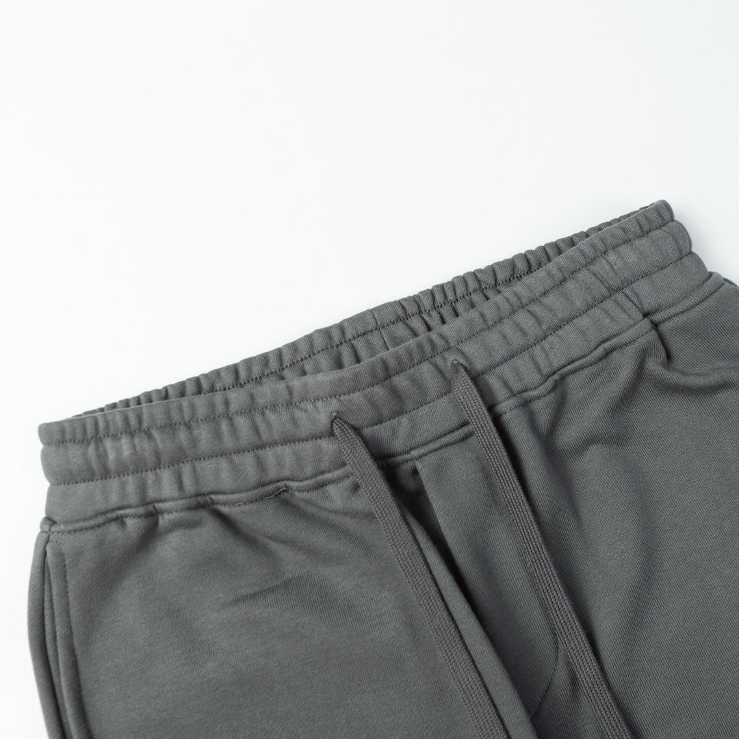 Charcoal gray sweatpants with elastic waistband, drawstring, and side seam pockets