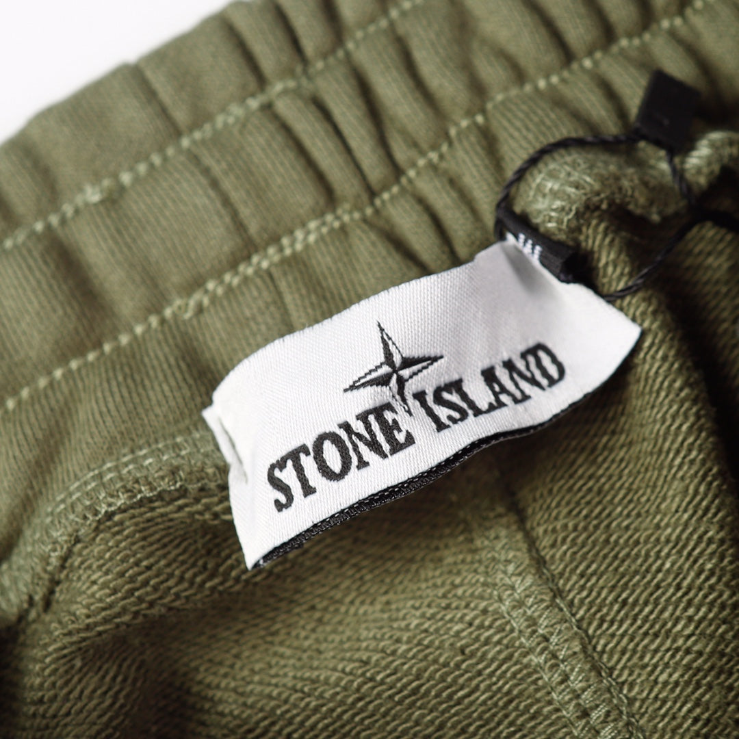 Olive joggers with Stone Island label on the drawcord area