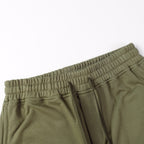 Olive joggers with elastic waistband and top view of drawcord opening