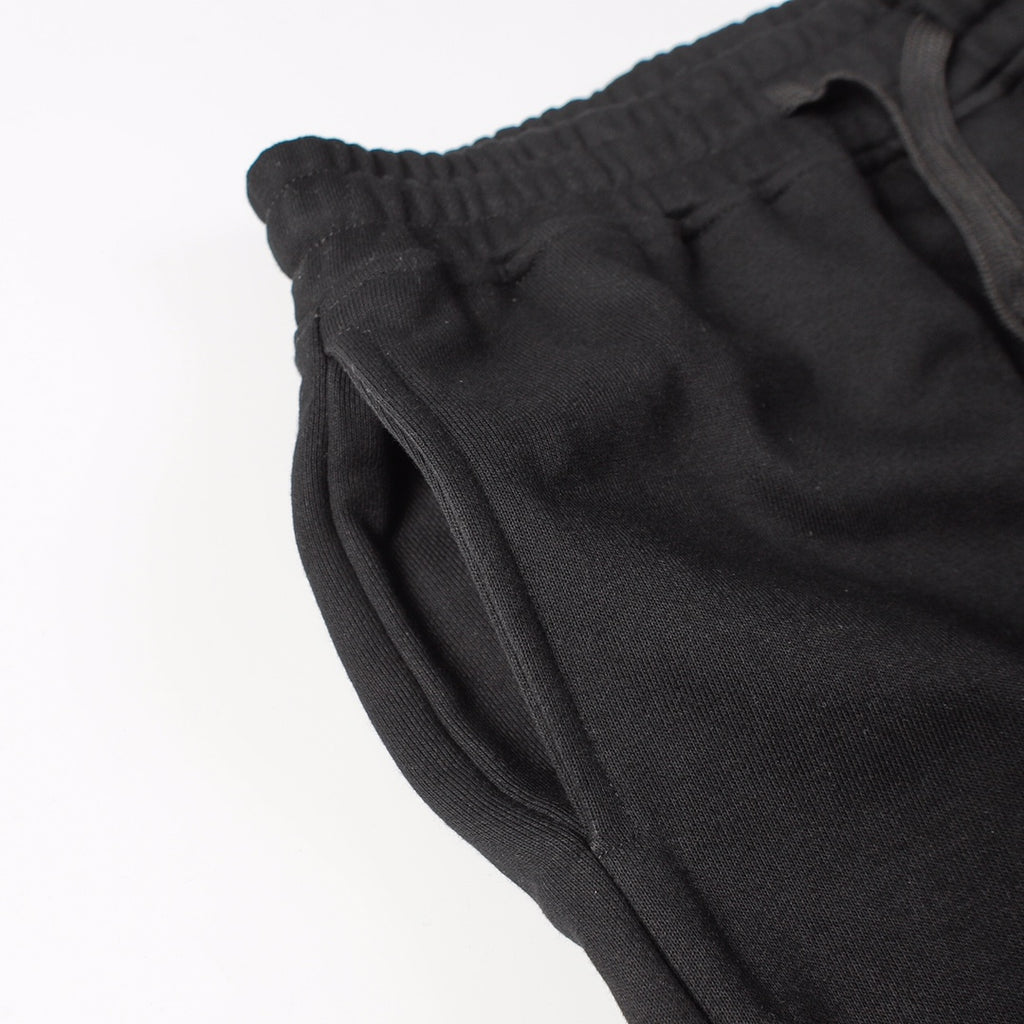 Stone Island black jogger pants close-up of side seam and curved hem